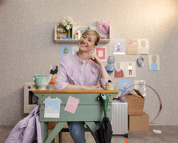 Linda at her desk surrounded by Hello Ruby materials and illustrations